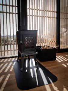 a black stove in a room with a large window at hejHUS w Strzyżach in Strzyże