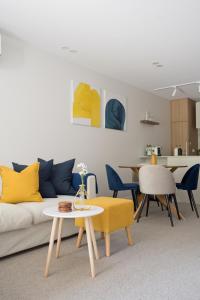 a living room with a couch and a table at Kashmir, Modern and luxury 2BR 2BA, Fast WiFi & Netflix, Free Parking, Central Location, near CBD in Canberra
