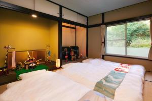 Postelja oz. postelje v sobi nastanitve Villa Hakone Kabuto 古民家旅館 150平米 バス停迄一分 準天然温泉 最大12名