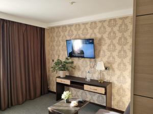 a hotel room with a television on a wall at Отель Бестау in Aksay