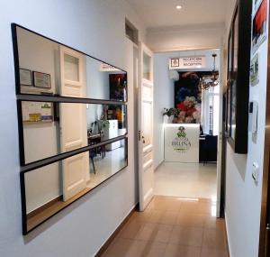 a hallway with a large glass display window at Hostal Bruña Paseo del Prado in Madrid