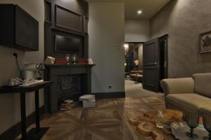 a living room with a couch and a fireplace at Forvm Experience in Trieste
