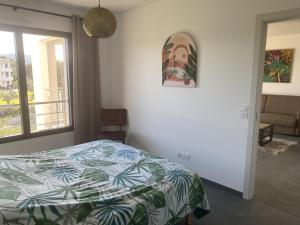 a bedroom with a bed and a window at Domaine d'Arca - Flaubert 11 - 4 pers - étage 1 in Porto-Vecchio