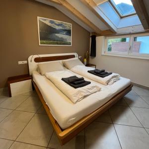 a bedroom with two beds in a room with a window at FLOW Village Apartment in Sarntal