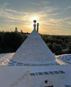 a statue of a bride on top of a building at RocknTrullo 2 bedroom by TripOstuni in Ostuni