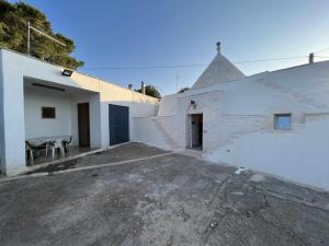 a parking lot in front of a white building at RocknTrullo 2 bedroom by TripOstuni in Ostuni
