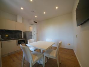 a kitchen with a table and chairs in a room at Castiglioncello Suite in Castiglioncello
