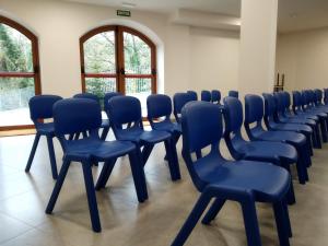 a row of blue chairs in a room at Casa de Colònies Casa Pare Coll in Gombreny