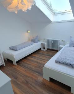 a attic room with two beds and a skylight at Five Seasons in Oberstaufen