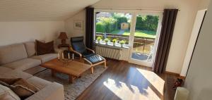 sala de estar con sofá, silla y ventana en Five Seasons en Oberstaufen