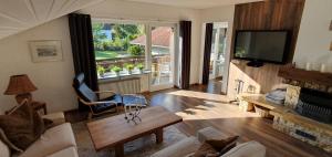 a living room with a fireplace and a tv at Five Seasons in Oberstaufen