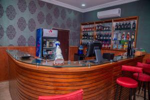 a bar in a restaurant with a dog on the counter at MAHOGANY HOTEL AND SUITES in Ibadan