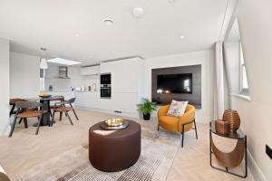 a living room with a couch and a table at Kentish Town Road in London