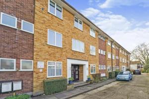 a brick building with a car parked in front of it at Spacious modern family bedroom in Central London in London