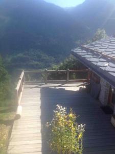 a wooden walkway with a view of a mountain at La Rosière Magnifique chalet savoyard 160 m2 T5 in Montvalezan