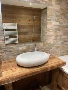 a white sink on a wooden counter in a bathroom at La Rosière Magnifique chalet savoyard 160 m2 T5 in Montvalezan