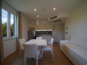 a kitchen and dining room with a table and chairs at Castiglioncello Suite in Castiglioncello