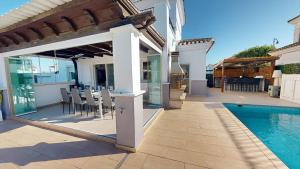a house with a patio and a swimming pool at La Torre Villa Bacalao - A Murcia Holiday Rentals Property in Roldán