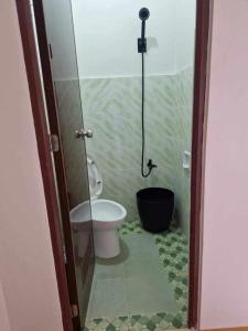 a bathroom with a toilet and a shower at Waray WaRaE Haven in Tacloban