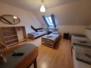 a living room with two beds and a mirror at Agroturystyka Sielska Kraina in Ząbkowice Śląskie