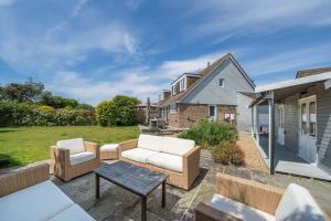 a patio with two chairs and a table at 40 Trelawny Way in Bembridge