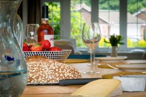 a table with bread and wine glasses and wine bottles at 40 Trelawny Way in Bembridge