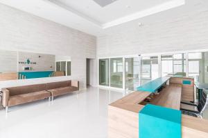 a living room with a couch and a table at Horizon Grey Apartment & Spa in Skopje