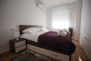 een slaapkamer met een bed met twee handdoeken erop bij Apartman Domagoj in Osijek