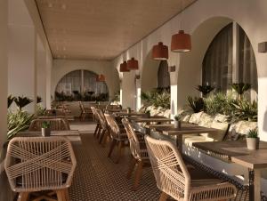 une rangée de tables et de chaises dans un restaurant dans l'établissement Marelen Hotel Zakynthos, à Kalamaki