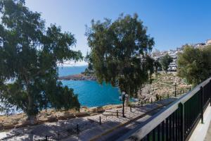 a view of a body of water from a balcony at Seafront Apartment in Piraeus in Piraeus