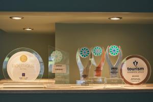 four trophies on display in a display case at Mirabilia Boutique Hotel in Kriopigi