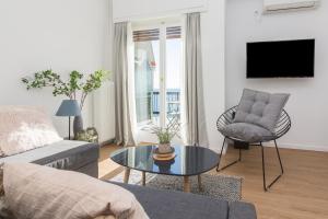 uma sala de estar com um sofá e uma mesa em Seafront Apartment in Piraeus em Pireu