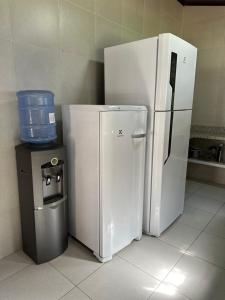 a white refrigerator and a trash can in a kitchen at Villa Patara in Marechal Deodoro