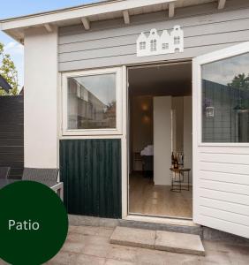 a sliding glass door on a house with the words patio at Studio Baarn with patio, airco, pantry, bedroom, bathroom, privacy - Amsterdam, Utrecht in Baarn