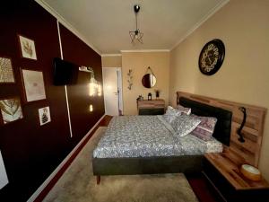 1 dormitorio con 1 cama y reloj en la pared en N3 Apartment, en Amadora