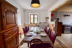 a dining room with a table and chairs in a kitchen at Maison au coeur des Bauges in Aillon-le-Jeune