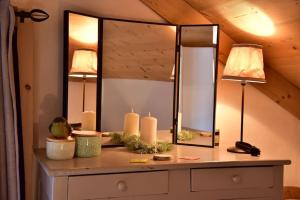 a dressing table with two lamps and a mirror at Maison au coeur des Bauges in Aillon-le-Jeune