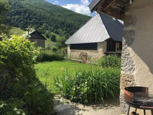 a house with a view of a yard with a building at Maison au coeur des Bauges in Aillon-le-Jeune