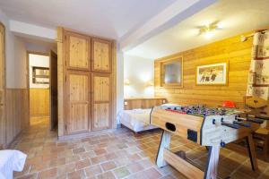 a bedroom with a bed and a table in it at les ours in La Plagne Tarentaise