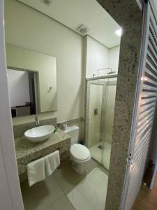a bathroom with a sink and a toilet and a shower at Hotel Recanto dos Ipes in Frutal