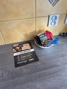 a table with a box of food and a plate of snacks at STUDIO Jana Pawła HGS HOME in Gorzów Wielkopolski