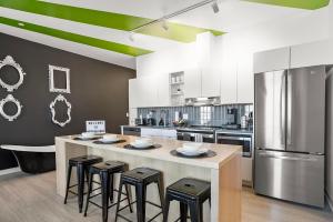 a kitchen with a large island with bar stools at Modern Home 3BD/3BA Free On-Street Parking & Wi-fi in Baltimore