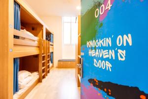 a room with bunk beds and a wall with the words opportunity on heaven is soon at The People - Marseille in Marseille