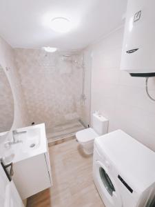 a white bathroom with a toilet and a sink at Artemide in Arona