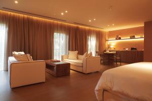 a hotel room with a bed and a living room at The Margi in Athens