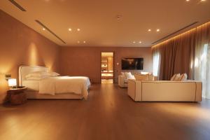 a bedroom with a bed and a living room at The Margi in Athens