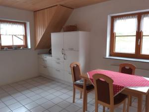 a kitchen with a table and a table and chairs at Ferienwohnung Lechleiter in Kappelrodeck