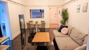 a living room with a couch and a table at Alluring and well-located 2 bed Randwick apartment in Sydney