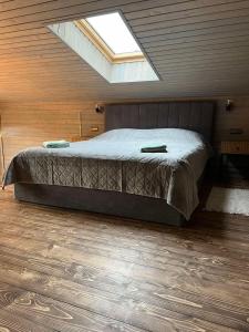 ein Schlafzimmer mit einem Bett in einem Zimmer mit einem Dachfenster in der Unterkunft База відпочинку „СІНАЙ“ in Sloboda