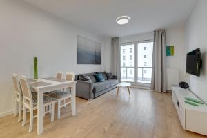 Televízia a/alebo spoločenská miestnosť v ubytovaní Apartament Nadmorskie Spektrum & Parking